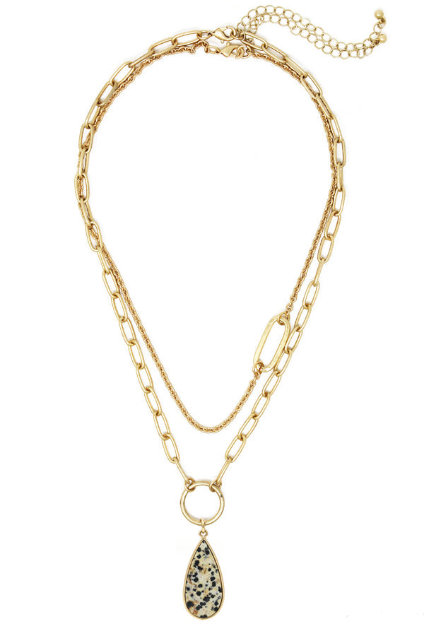 A golden chained necklace with a teardrop stone